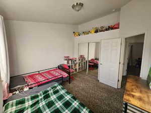 Bedroom featuring carpet floors and a closet