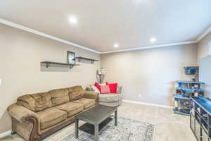 Living area featuring light carpet, recessed lighting, and crown molding