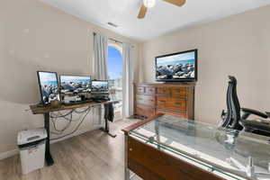 Office space featuring a ceiling fan and light wood-style flooring