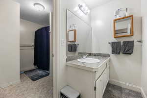 Bathroom with vanity and a shower with shower curtain