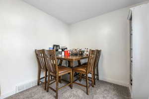 Dining room with carpet and baseboards