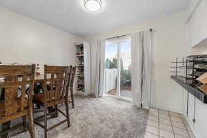Dining room with baseboards and light tile patterned floors