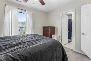 Bedroom with light carpet and ceiling fan