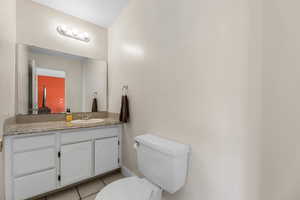 Bathroom with tile patterned floors and vanity