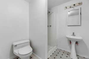 Bathroom with a shower stall and toilet