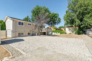 Back of house with a gate and a wooden deck