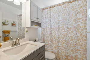 Full bathroom featuring vanity and curtained shower
