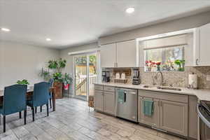 Kitchen featuring stainless steel appliances, tasteful backsplash, wood tiled floors, recessed lighting, and gray cabinetry