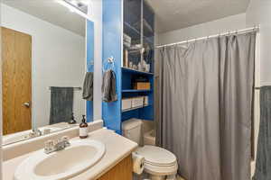 Bathroom with vanity and shower / tub combo with curtain
