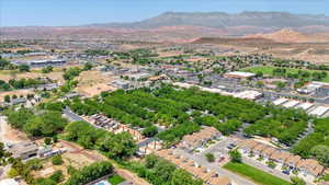 Aerial view of property and surrounding area with mountains
