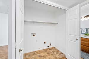Washroom with gas dryer hookup, washer hookup, and hookup for an electric dryer
