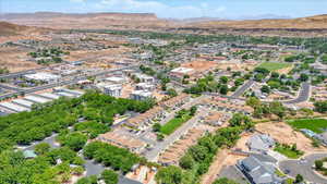 Aerial view of property and surrounding area featuring mountains