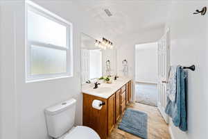 Bathroom featuring double vanity and toilet