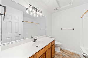 Bathroom featuring vanity and washtub / shower combination