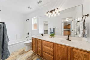 Full bathroom featuring double vanity and  shower combination