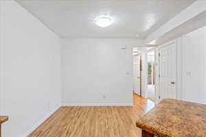 Entrance foyer featuring light wood finished floors and a textured ceiling