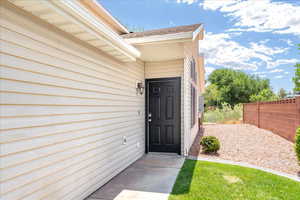 Entrance to property with roof with shingles