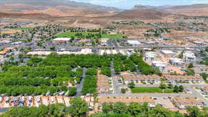 Aerial view of property and surrounding area with a mountainous background