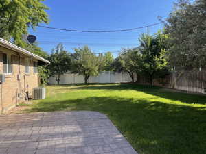 Fenced backyard featuring a patio