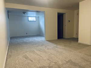Carpeted spare room with baseboards