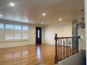 Foyer with light wood-style floors and recessed lighting