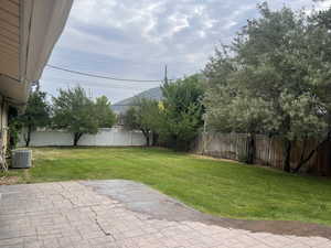 Fenced backyard with a patio