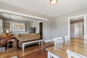Living room with dark wood finished floors and a textured ceiling