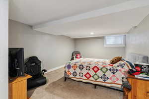 Carpeted bedroom featuring a textured wall
