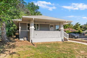 View of front of house with a front lawn and covered porch