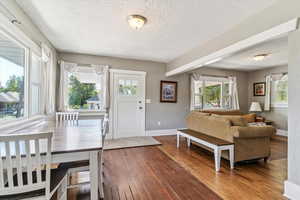 Foyer featuring a textured ceiling, hardwood / wood-style floors, and plenty of natural light