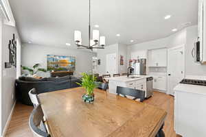 Dining area with a chandelier, light wood finished floors, and recessed lighting