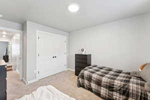 Bedroom with carpet flooring and a closet
