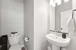 Half bath with toilet and a sink