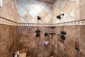 Bathroom featuring a tile shower
