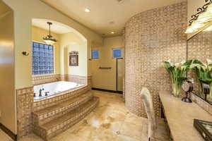 Bathroom with a bath, recessed lighting, and tile patterned flooring