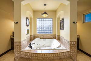 Full bath with a jetted tub