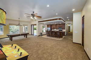 Recreation room featuring light carpet, arched walkways, billiards table, recessed lighting, and a ceiling fan