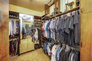 Walk in closet featuring carpet flooring