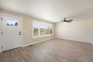 Foyer entrance with light wood-type flooring and ceiling fan