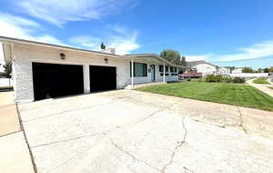 Ranch-style house featuring brick siding, driveway, an attached garage, and a front lawn