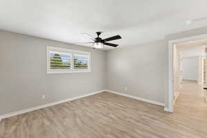 Spare room featuring light wood-type flooring and a ceiling fan
