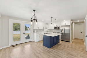 Kitchen with appliances with stainless steel finishes, light countertops, backsplash, plenty of natural light, and recessed lighting