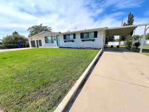 View of front of house featuring driveway and brick siding