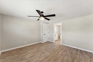 Spare room featuring ceiling fan and light wood-style flooring