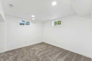 Below grade area with carpet flooring and recessed lighting