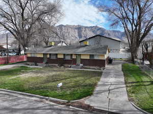 View of front of property featuring a mountain view and brick siding