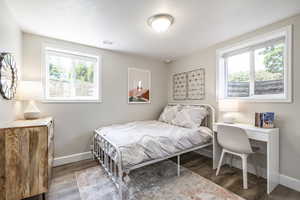 Bedroom featuring baseboards and wood finished floors
