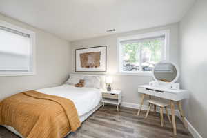 Bedroom featuring light wood-style floors and baseboards