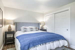 Bedroom featuring wood finished floors and a closet