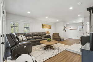 Living area with wood finished floors and recessed lighting